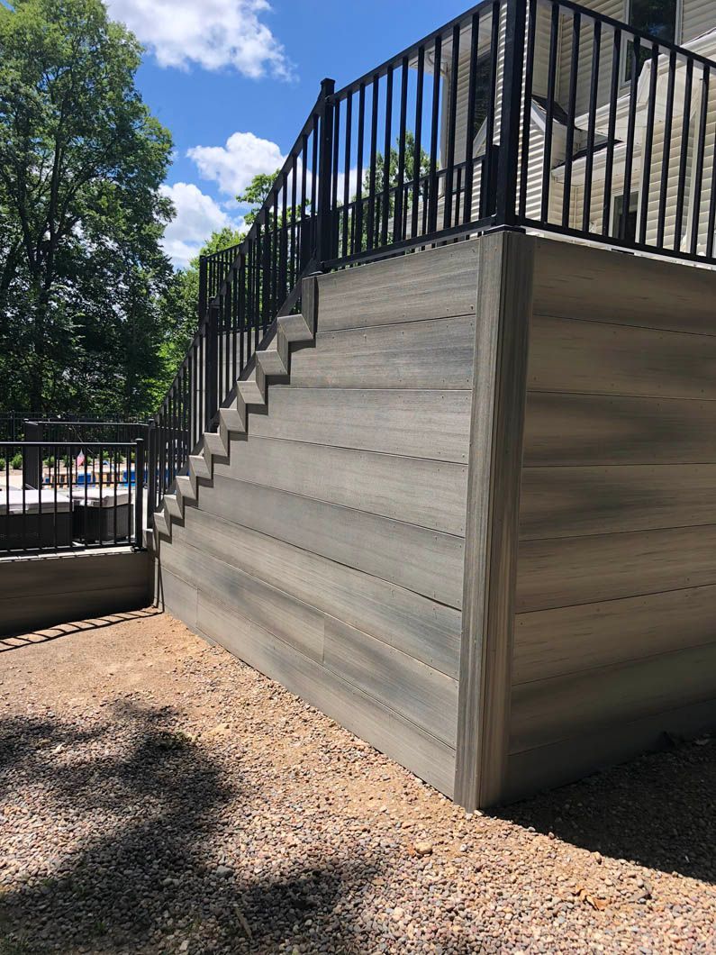 There are stairs leading up to a deck with a railing.