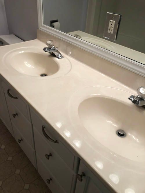 A bathroom with two sinks and a mirror