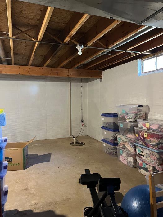 A basement filled with boxes and a bicycle.