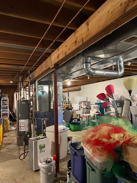 A basement filled with lots of boxes and appliances.