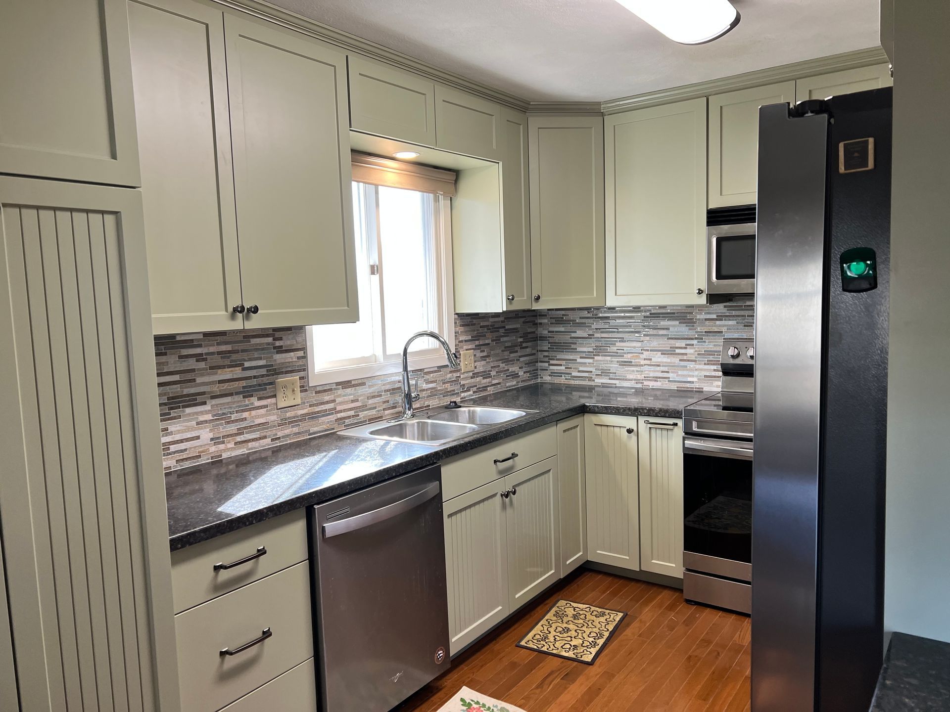 A kitchen with white cabinets and stainless steel appliances