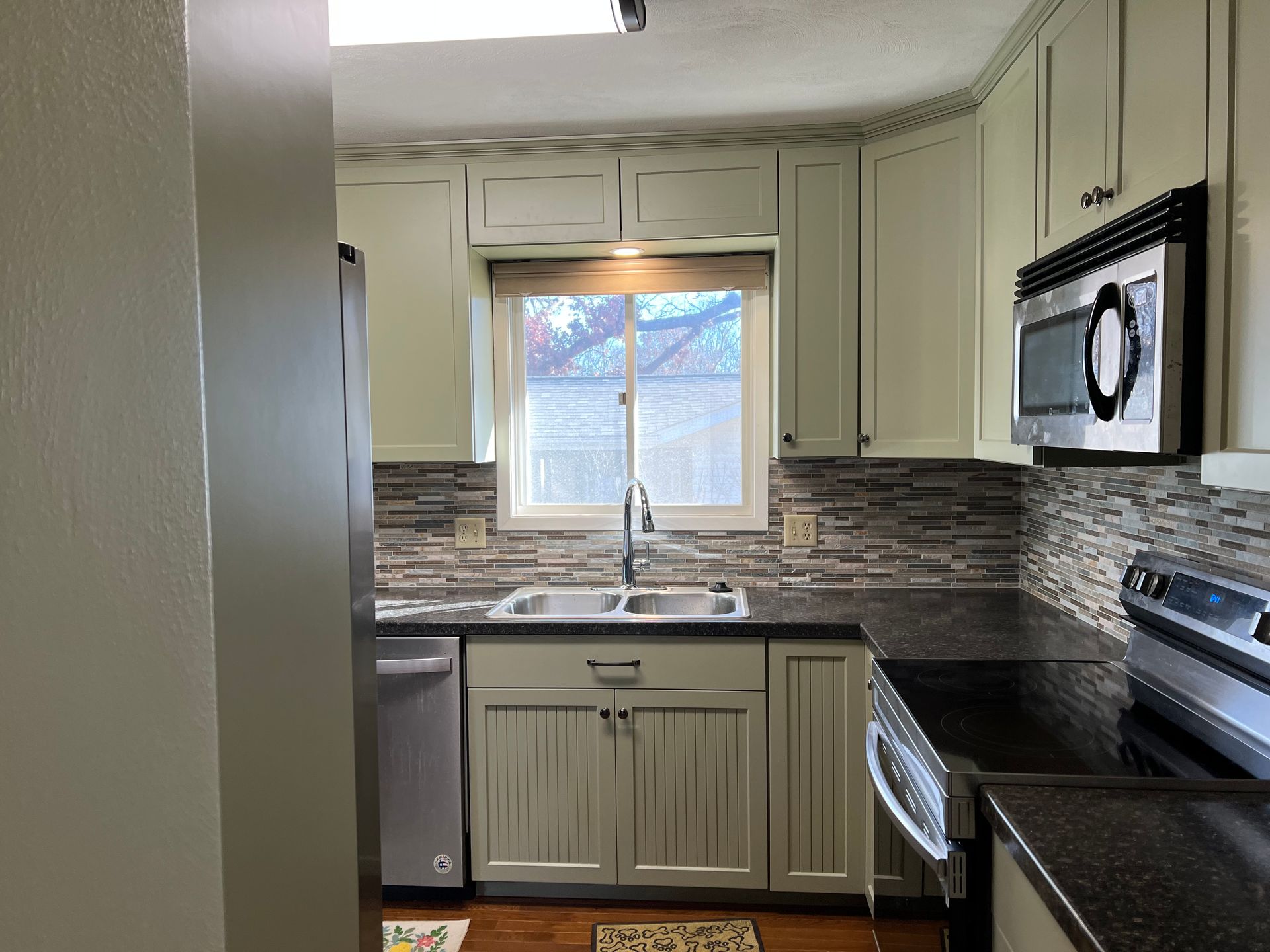 A kitchen with stainless steel appliances and white cabinets