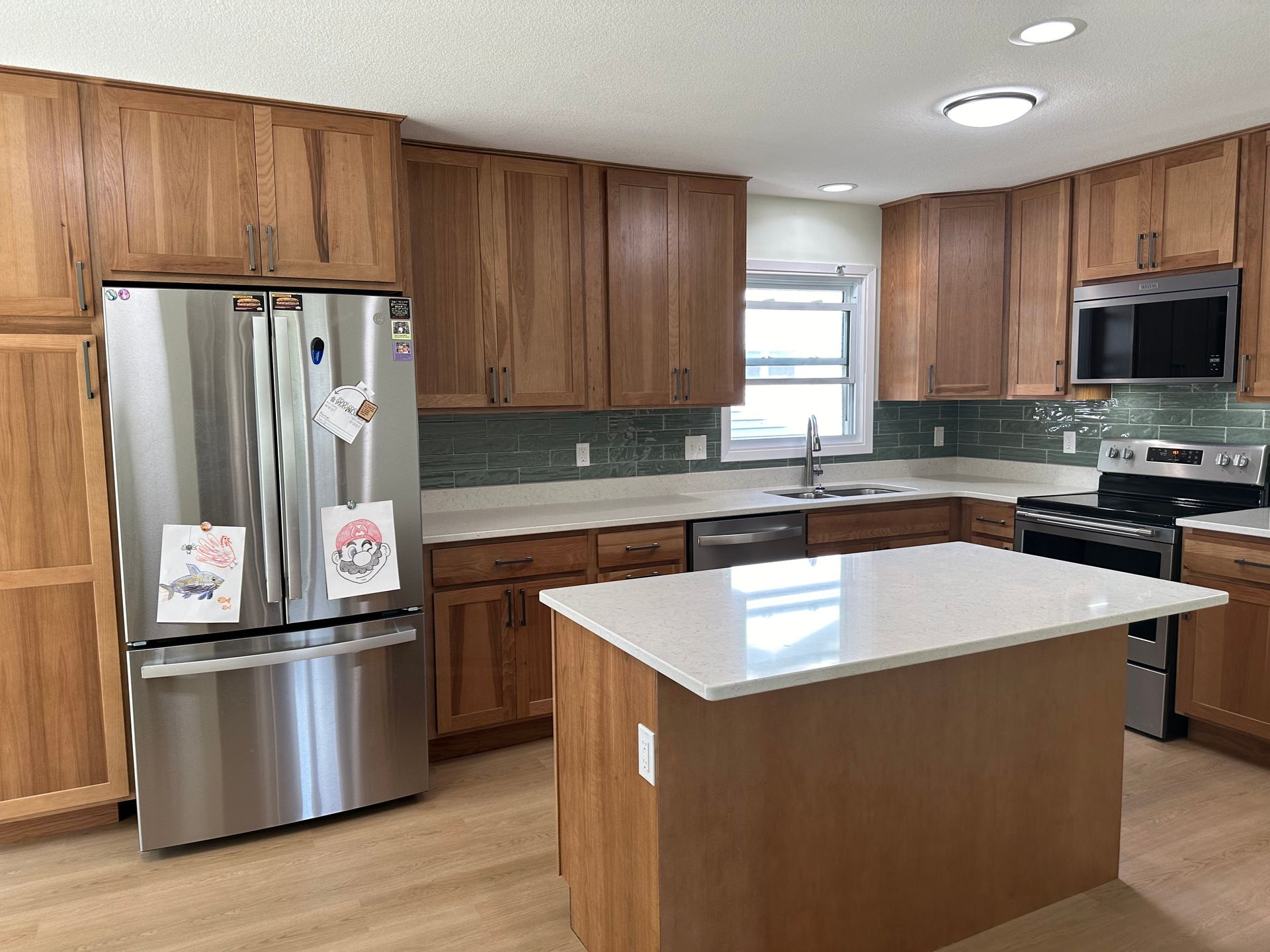 A kitchen with stainless steel appliances and wooden cabinets