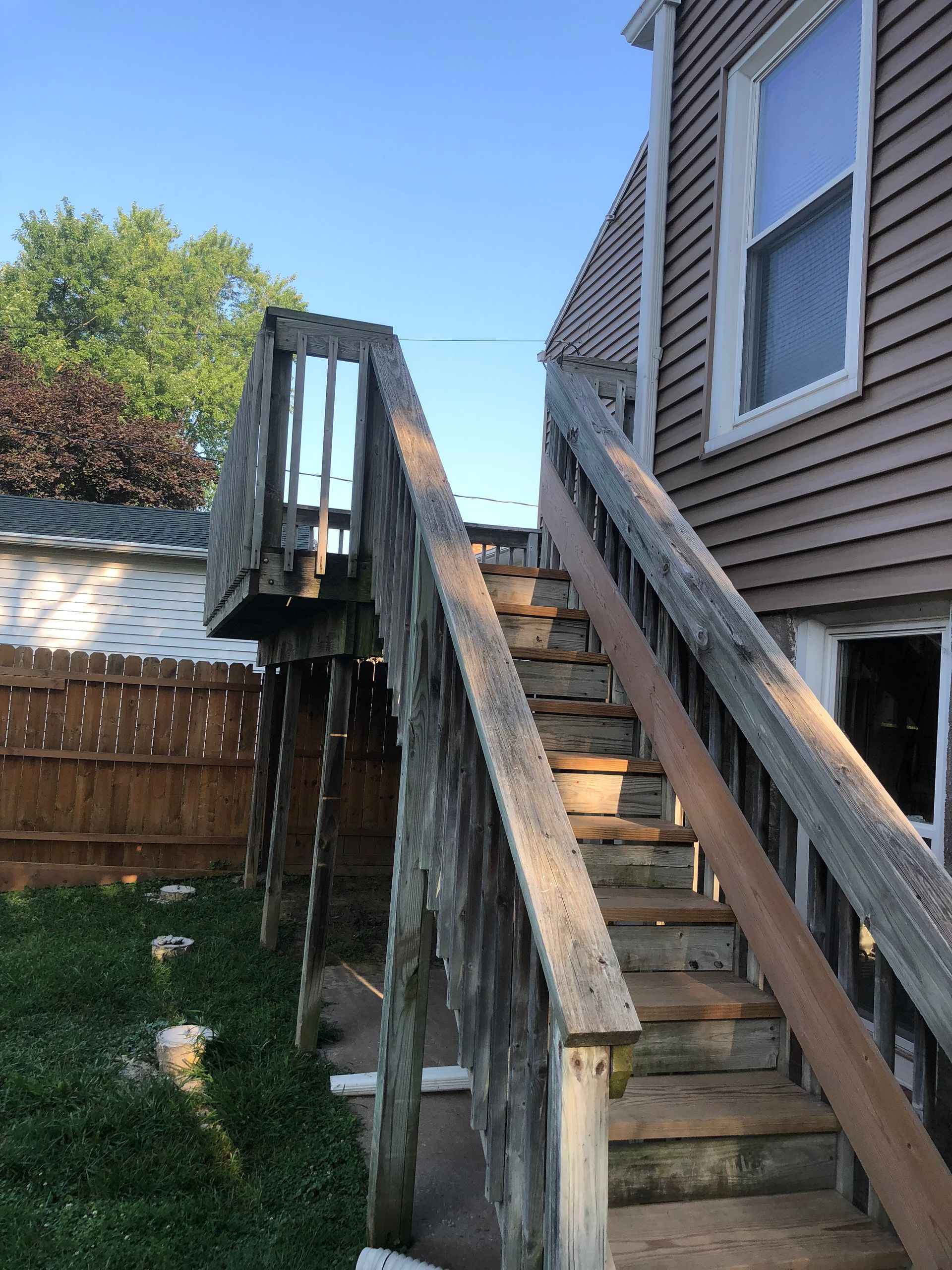 A wooden deck with stairs leading up to it