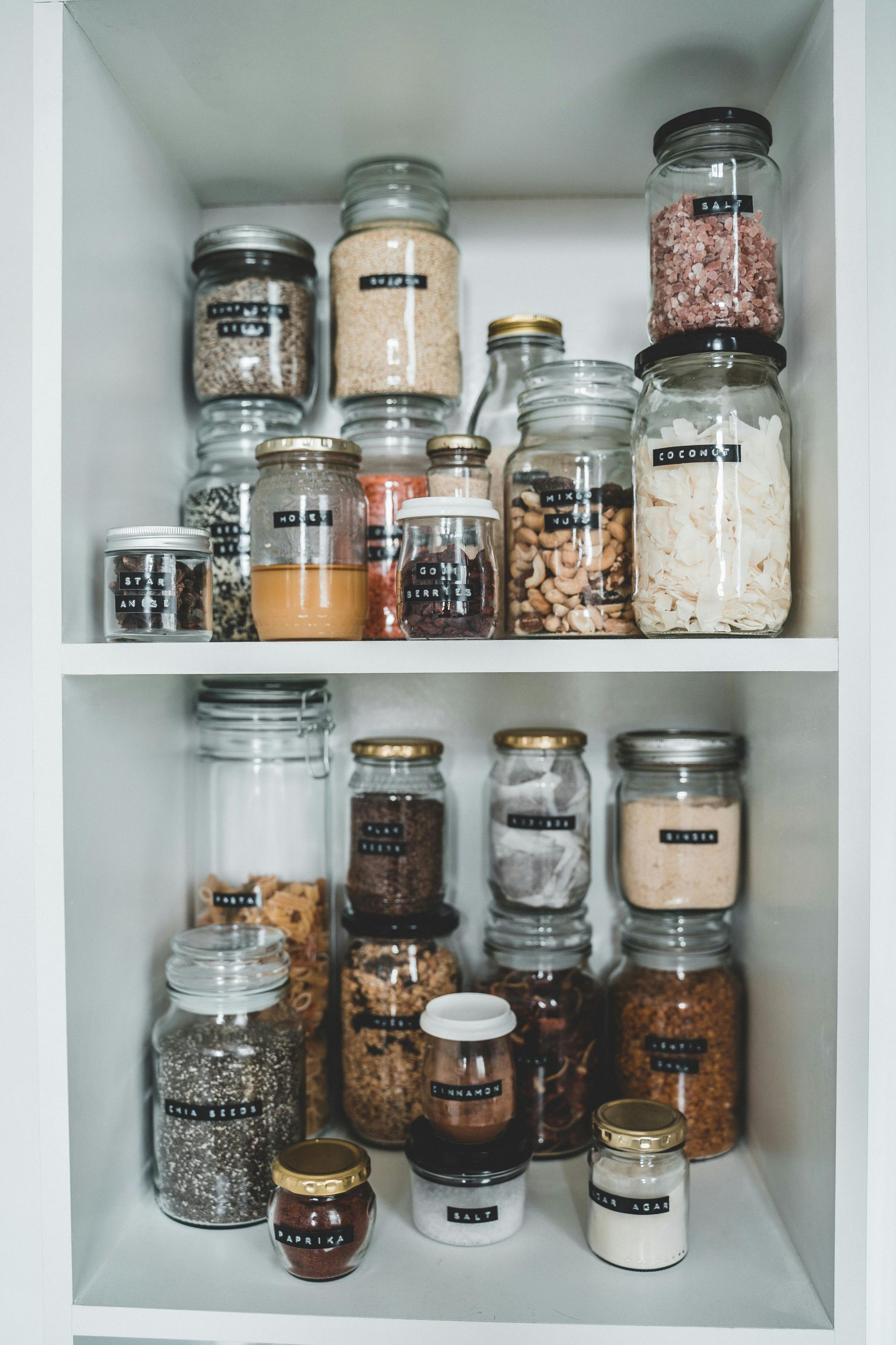 A pantry filled with jars and bottles of food.