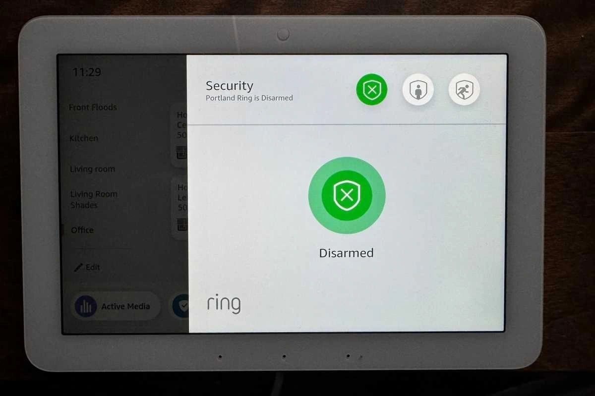 A white tablet with a green circle on the screen.