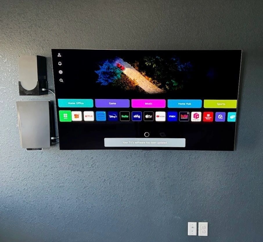 A flat screen tv is mounted on a wall