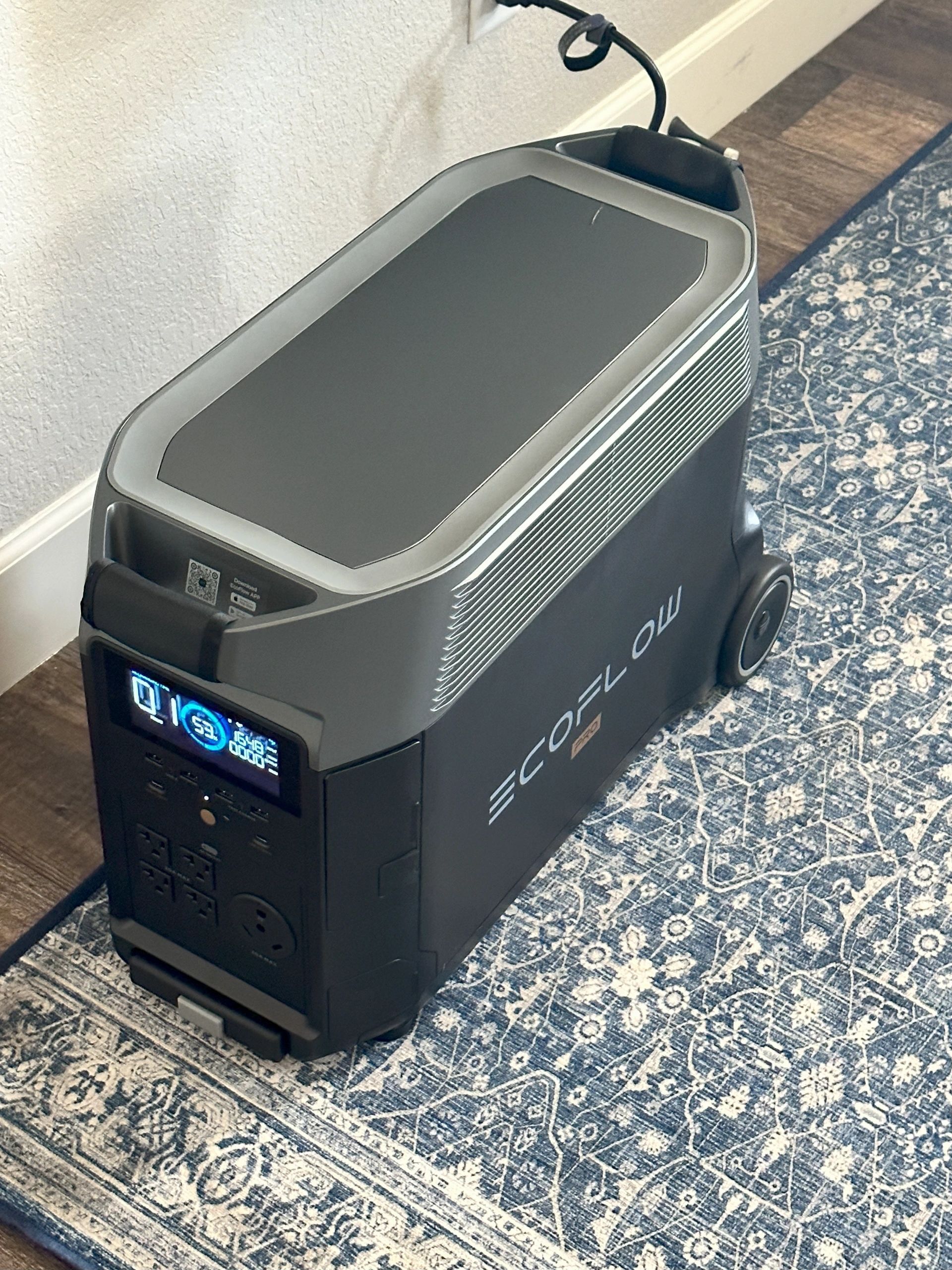 A black box is sitting on top of a blue rug.