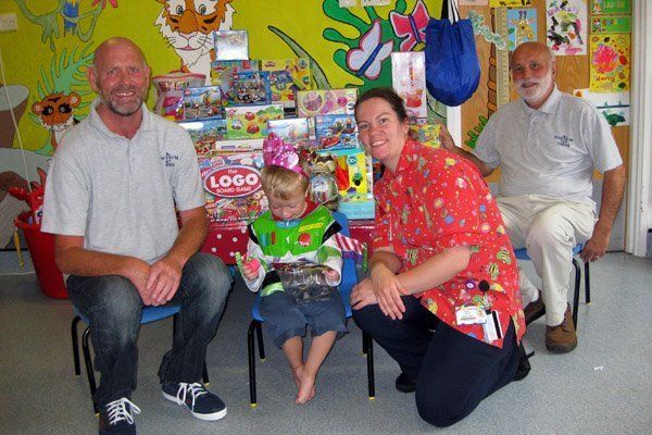 Eager hands get to grips with Steve and Glyn's delivery of toys at the Rainbow Ward at the QEQM Hospital Margate.