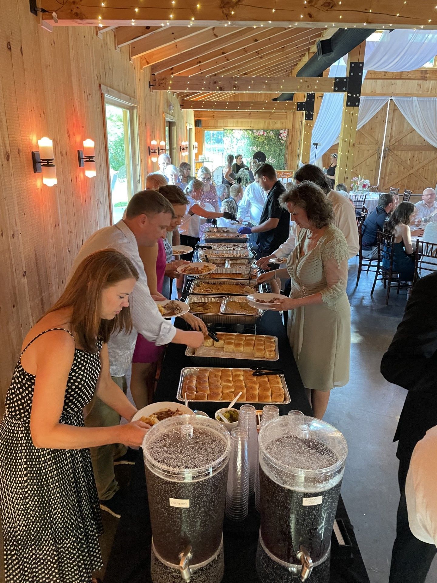 A sandwich with meat and onions on a bun on a wooden table.