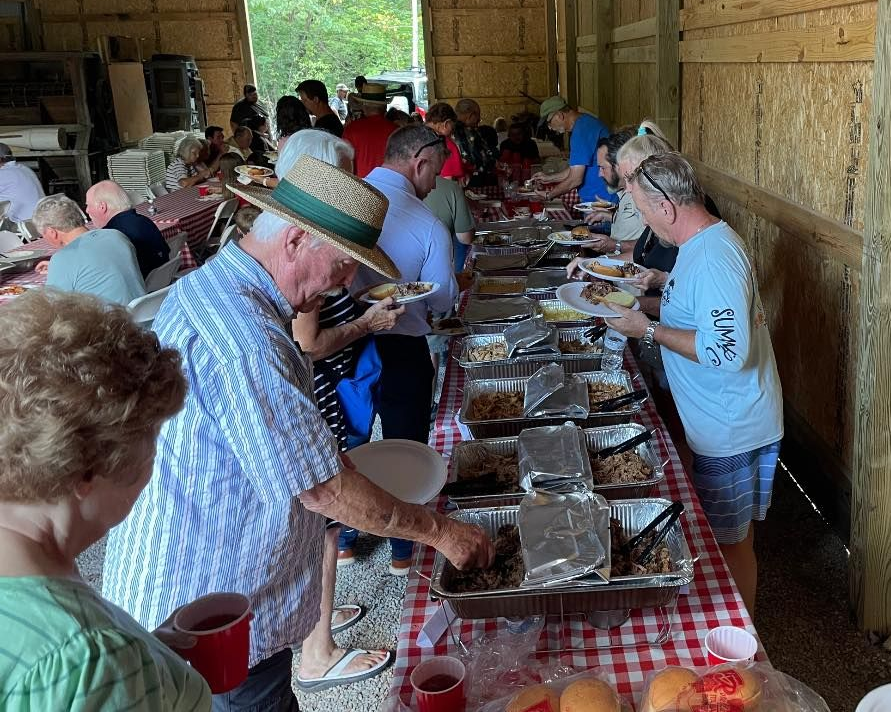 A bunch of ribs are cooking on a grill.