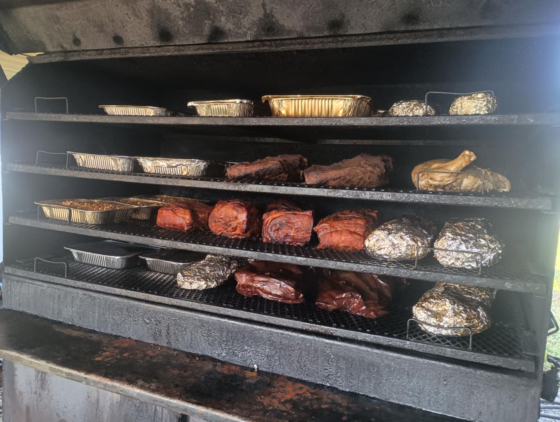 Chicken wings are being cooked in a smokehouse.