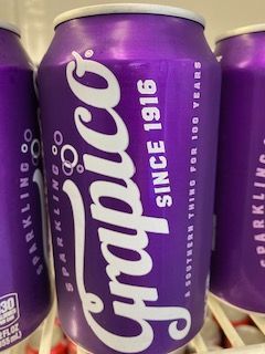 A bunch of ribs are cooking on a grill.