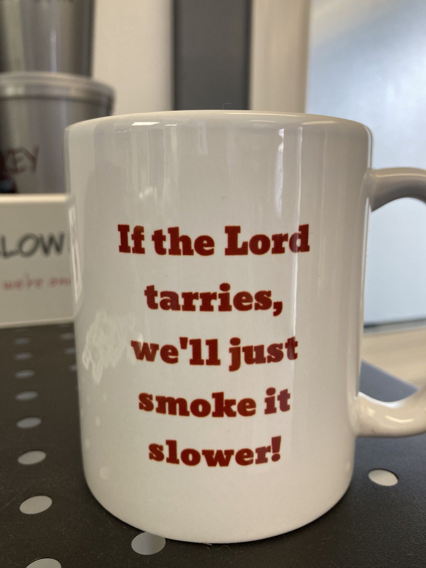 White coffee mug with red text: 