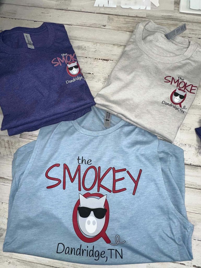 A jar of smokey q sits on a refrigerator shelf