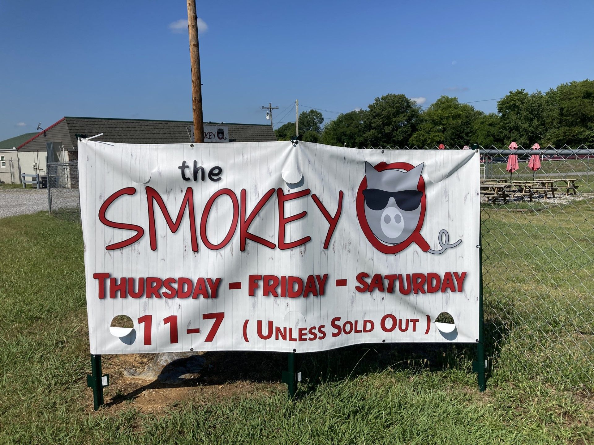 A bunch of ribs are cooking on a grill.