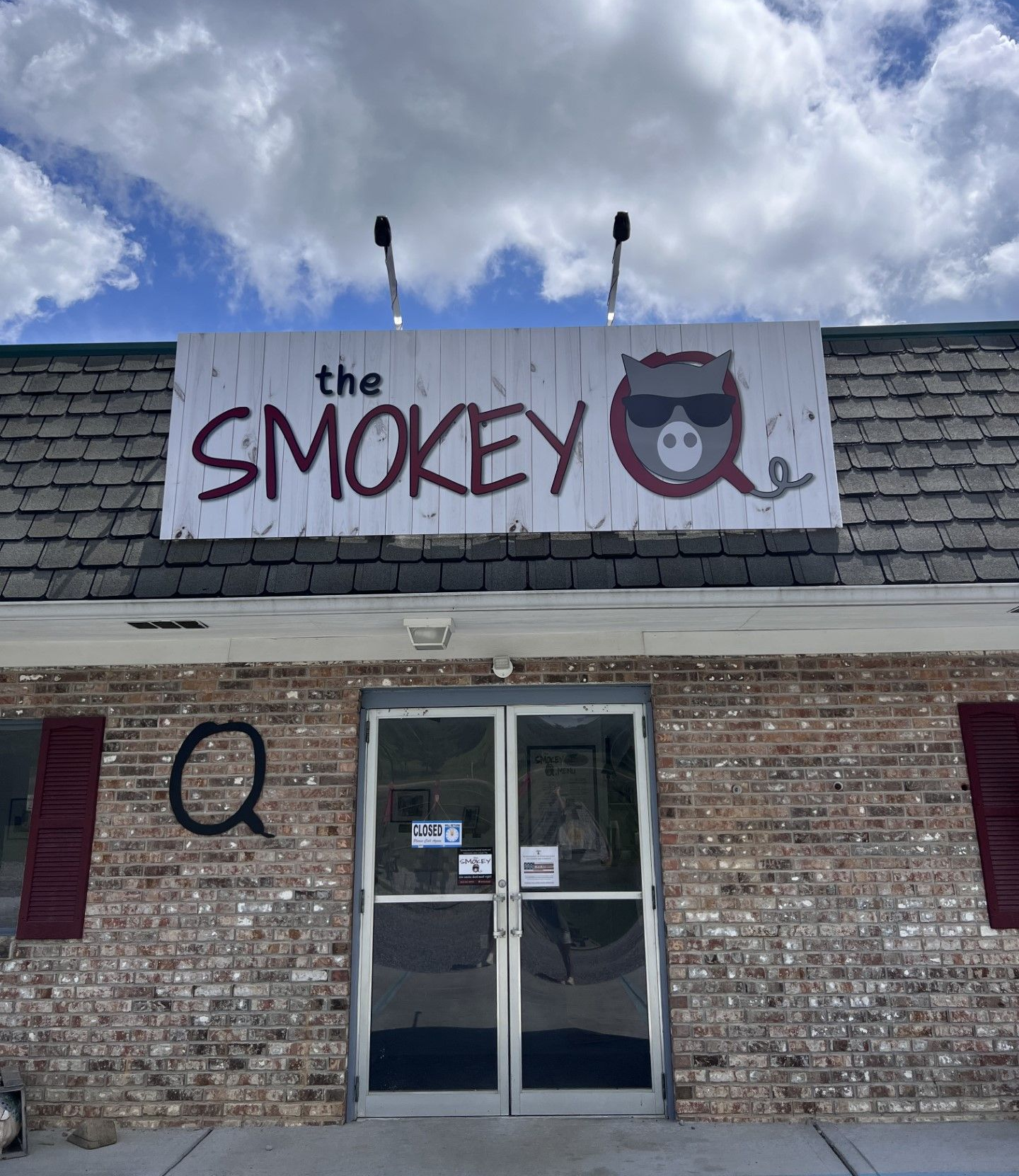 A black and white photo of a trailer under a canopy