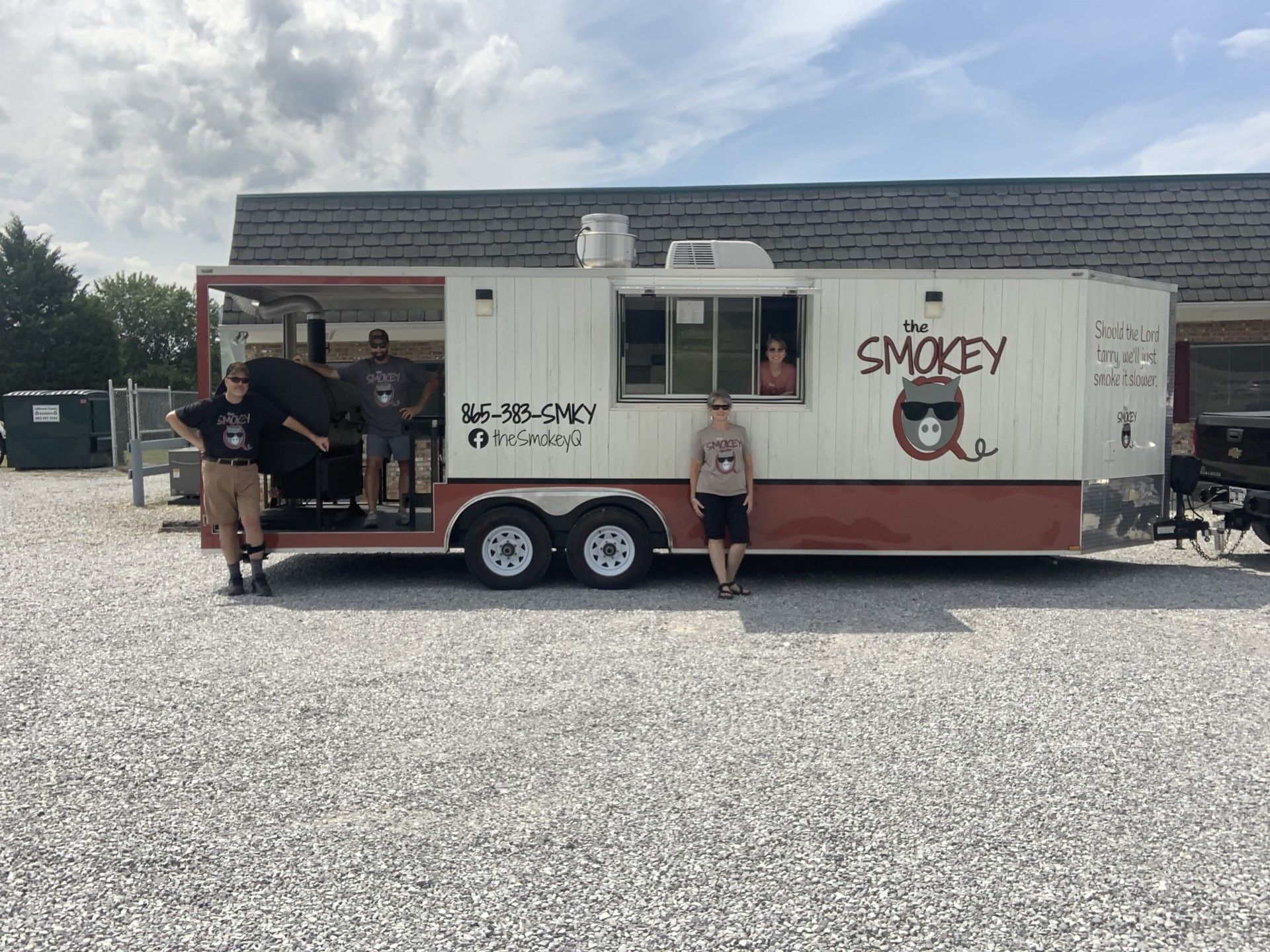 A jar of smokey q sits on a refrigerator shelf