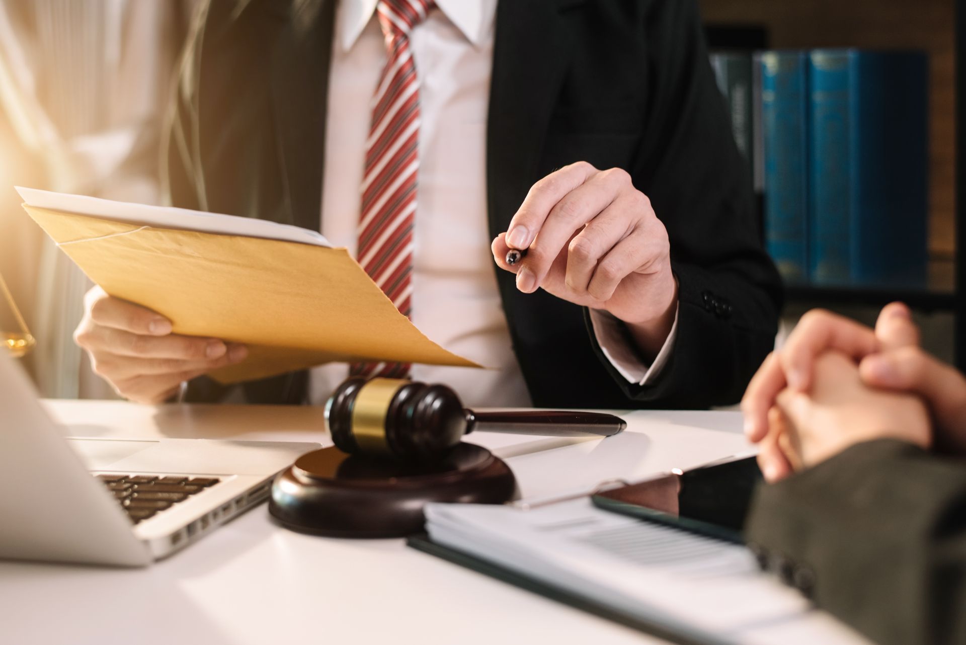 Judge writing on paperwork, gavel on the table, legal setting.