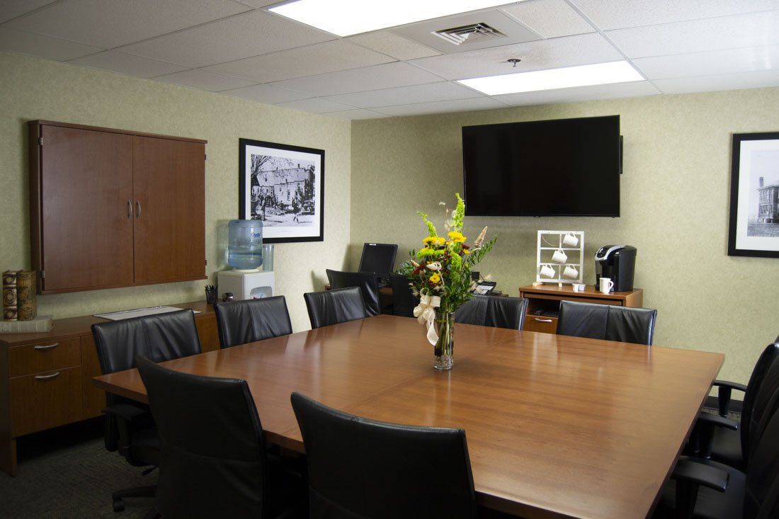A conference room with a large table and chairs