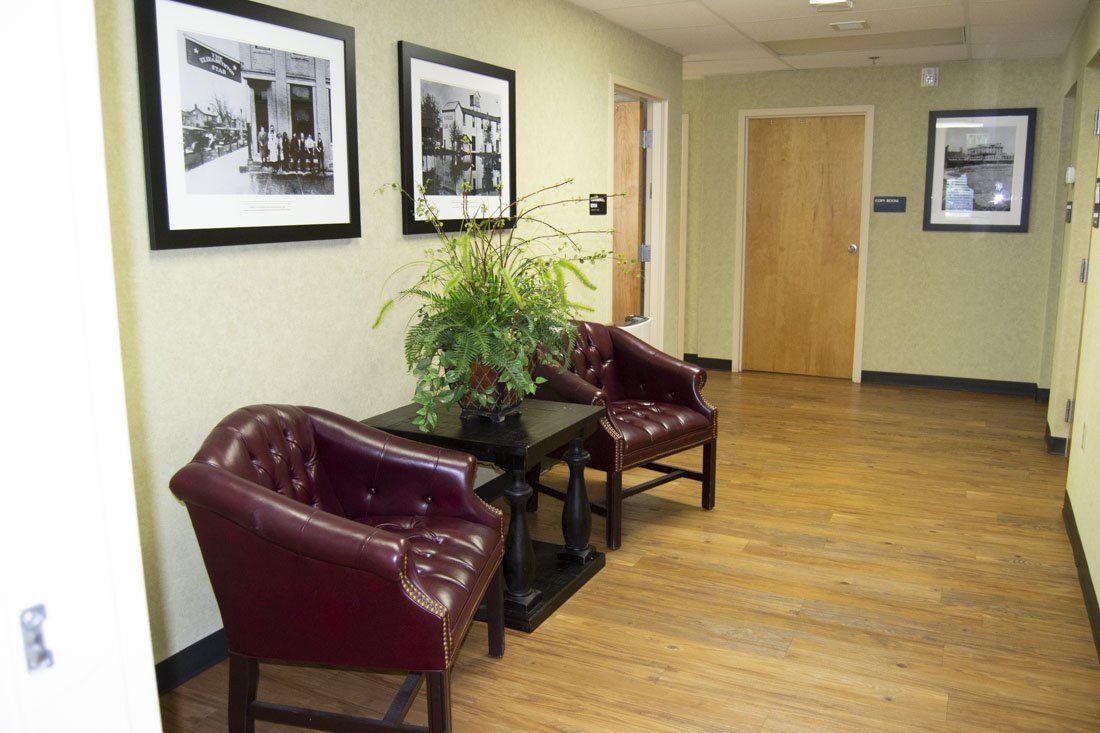 A hallway with two chairs and a table in it