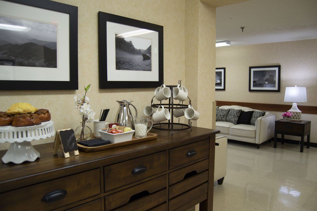 A wooden table with a tray of food on it in a living room.