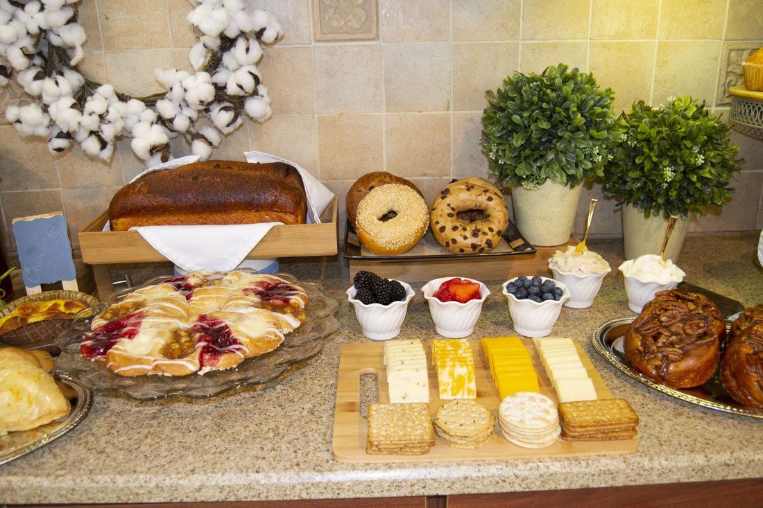 A table with a variety of breads and pastries on it