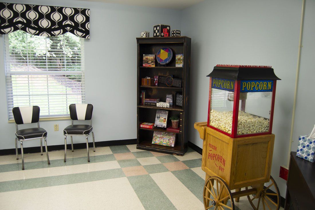A room with chairs and a popcorn machine
