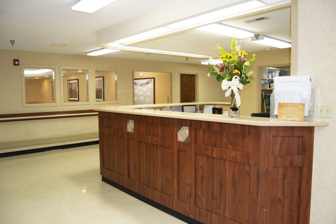 A reception desk with a vase of flowers on it