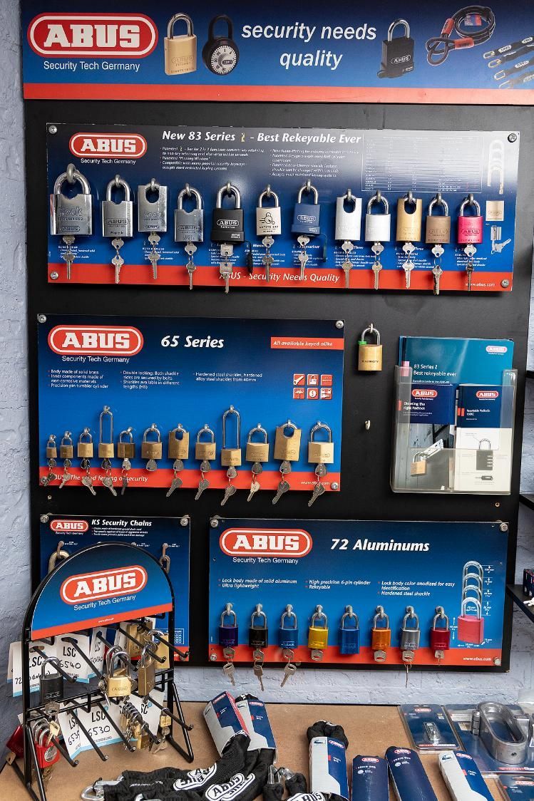 ABUS Padlock Display in a Store, Showing Various Security Locks in a Variety of Colors and Styles — Active 24/7 Locksmith and Security Services in Tuncurry, NSW