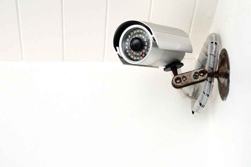 A Security Camera Is Mounted on A White Wall — Active 24/7 Locksmiths Forster In Tuncurry, NSW