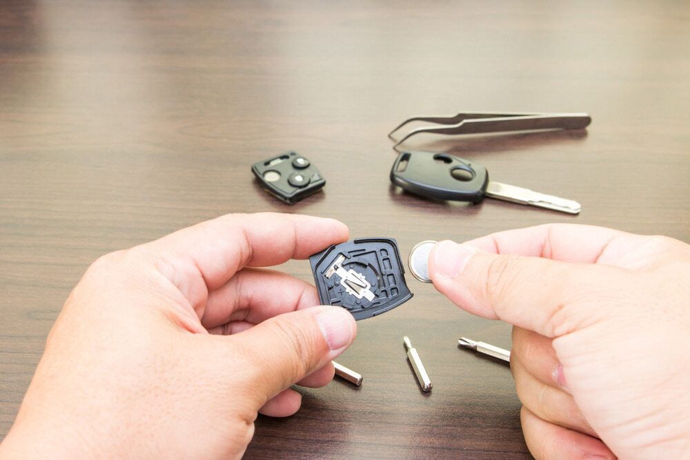 A Person Is Holding a Car Key in Their Hand — Active 24/7 Locksmiths Forster In Forster, NSW