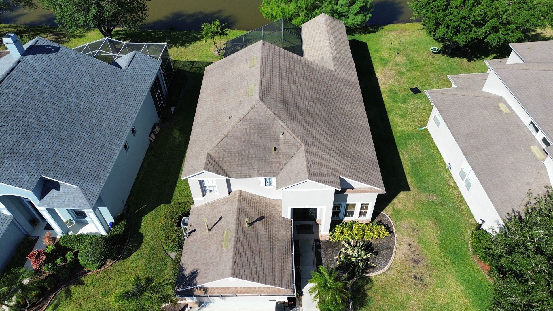 An aerial view of a house with a roof that is covered in shingles.