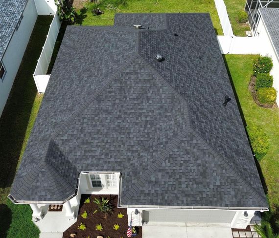 An aerial view of a house with a black roof.