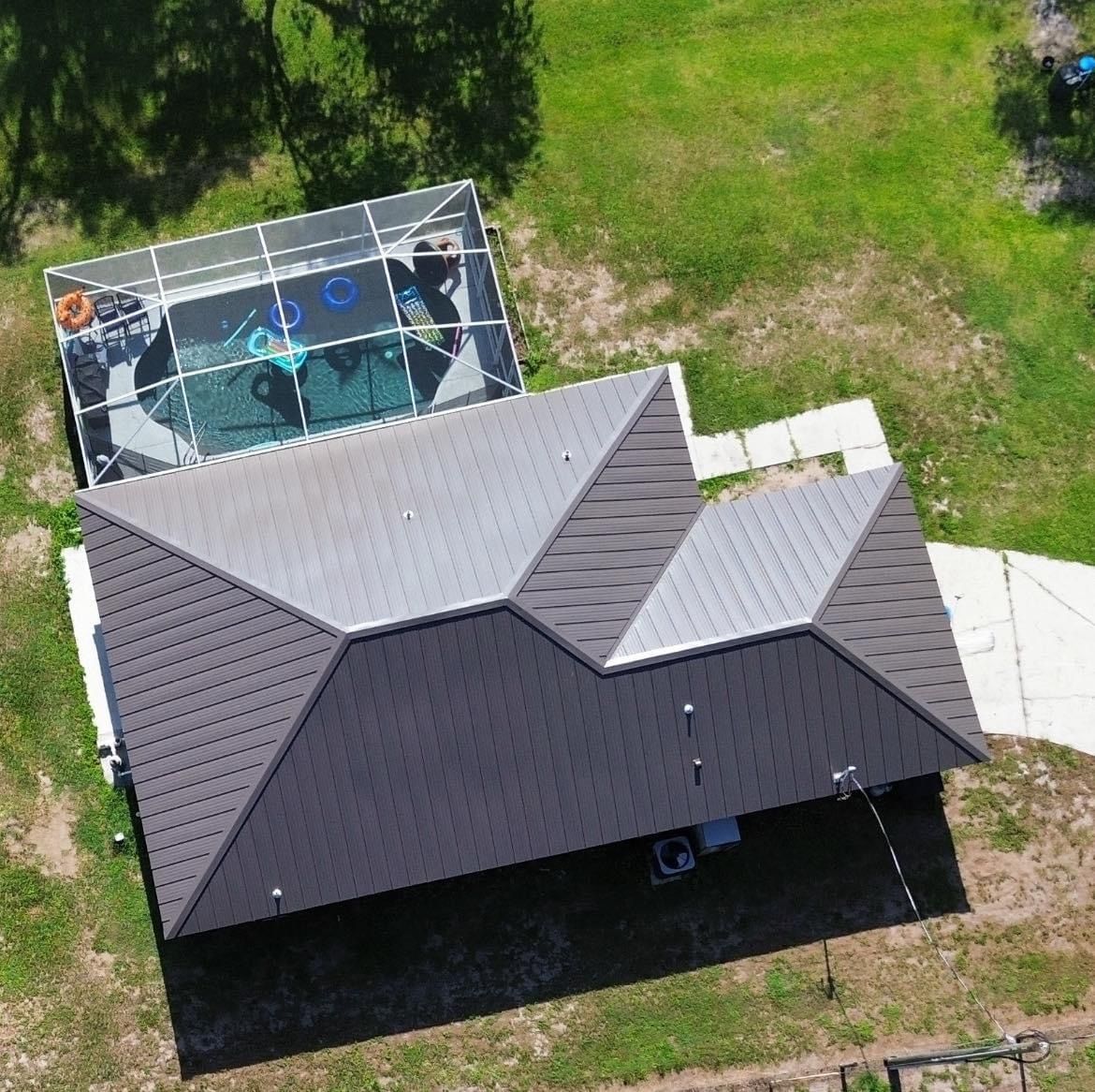 An aerial view of a house with a pool on top of it