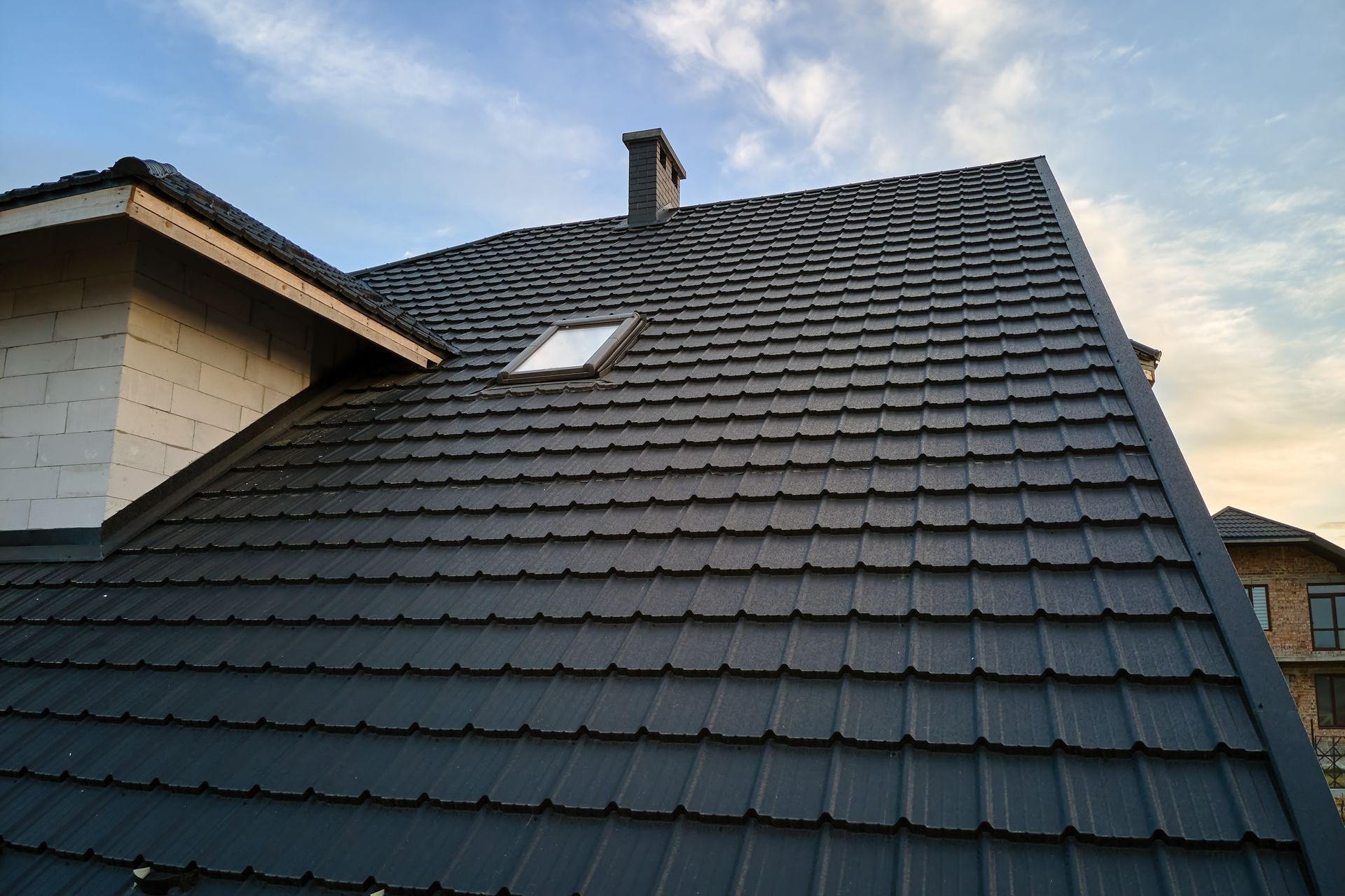 A roof with a skylight and a chimney on it