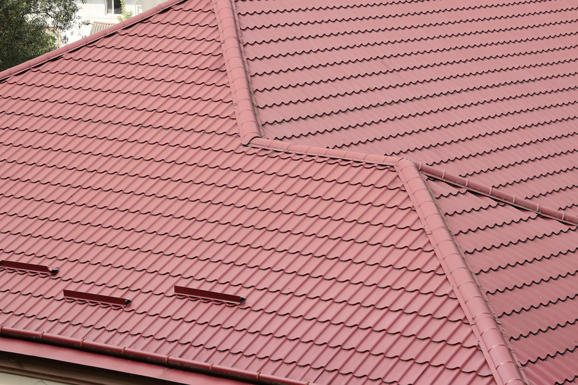 A close up of a red roof with snow drains