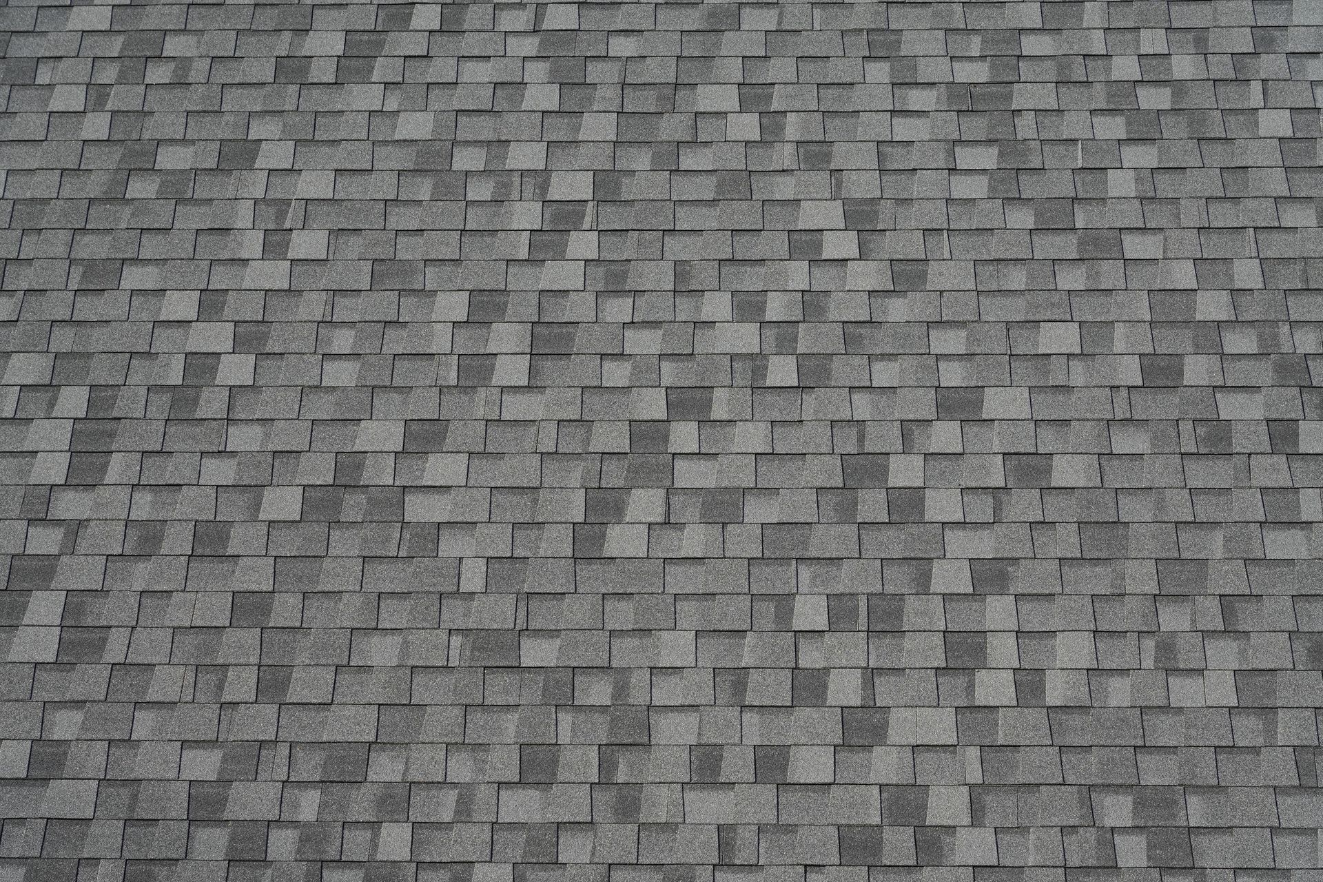 A close up of a roof with a lot of shingles on it.