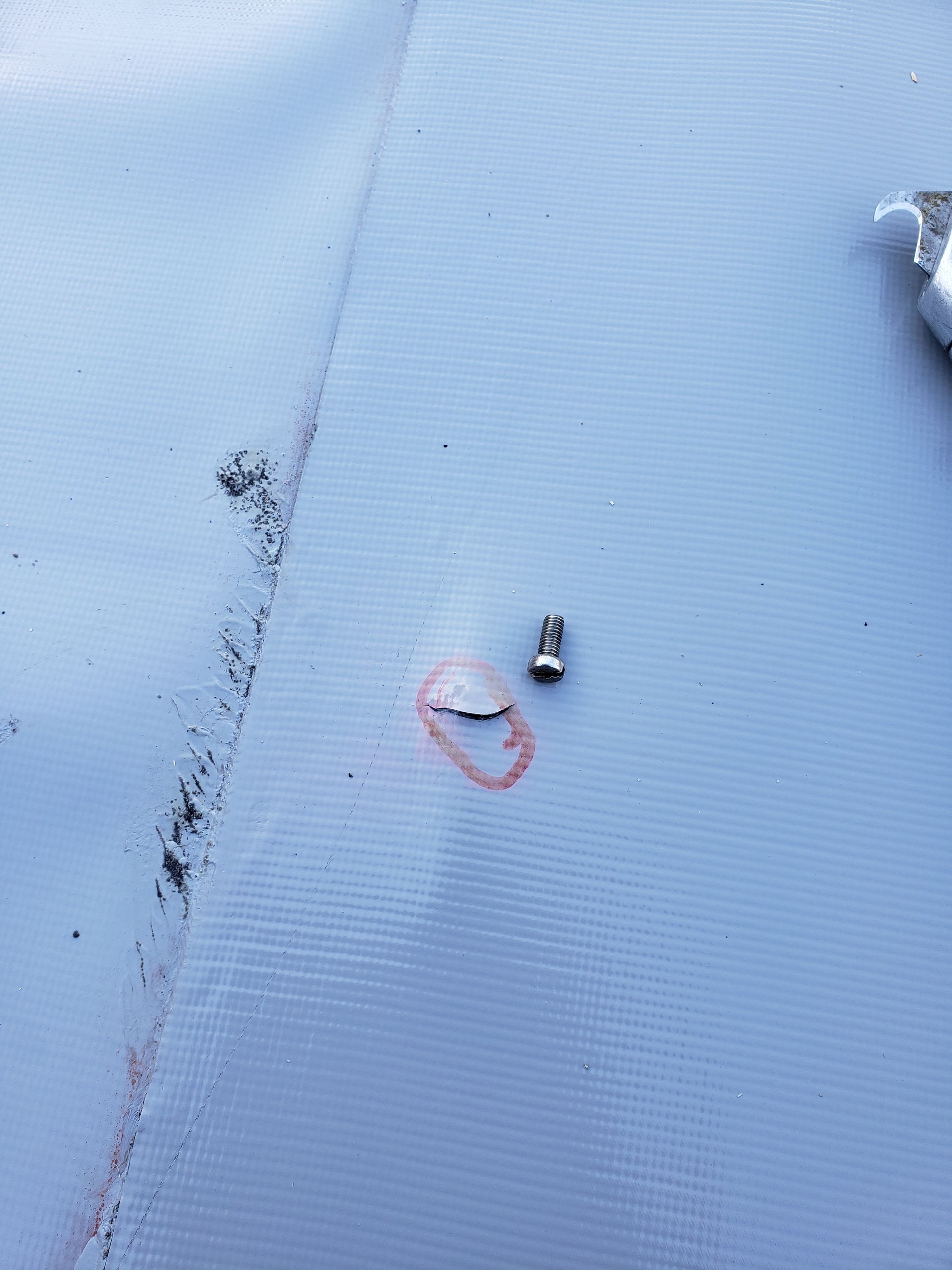 A close up of a screw on a white surface.