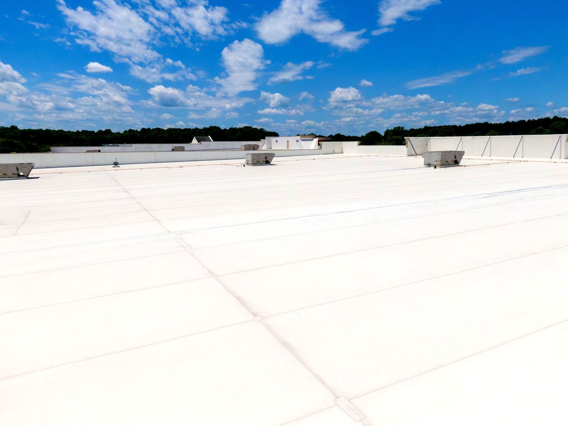 A large white roof with a blue sky in the background.