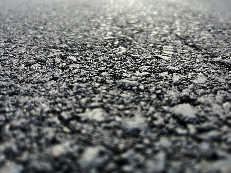 A close up of a piece of asphalt on a road.