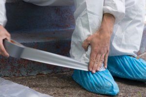 Unattended Death Cleanup — Man takes biosuit around ankle
