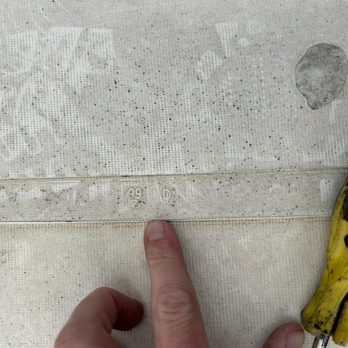 Overhead view of a commercial building rooftop with multiple curved metal structures and flat rooftops.