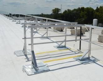 Aluminum roof guardrail system on a flat roof.
