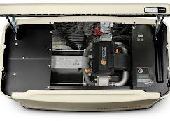 The engine of a generator is shown with the lid open.