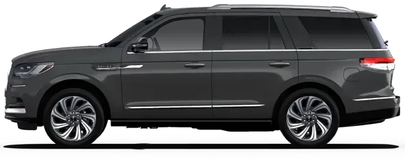 A black ford expedition is parked in front of a garage.