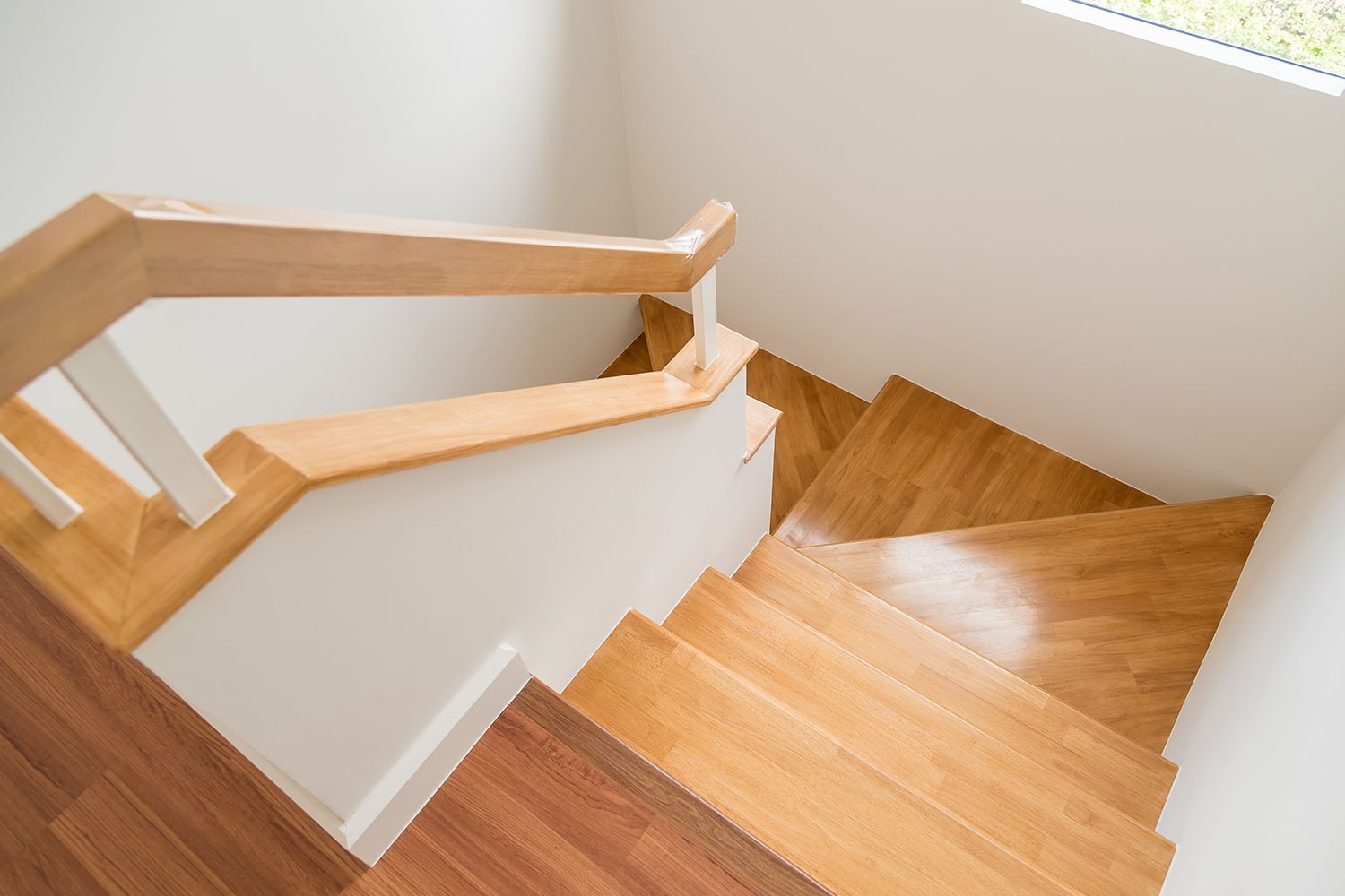 Close-up view of a timber handrail and modern wooden staircase.