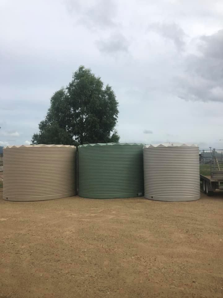 Three Water Tanks Are Stacked on Top of Each Other in a Dirt Field — MacCallum & Company In Scone, NSW
