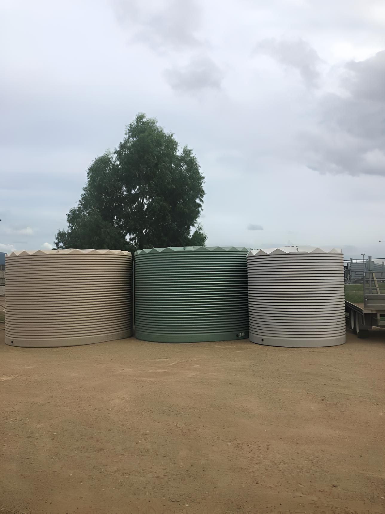Three Water Tanks Are Stacked on Top of Each Other in a Dirt Field — MacCallum & Company In Scone, NSW