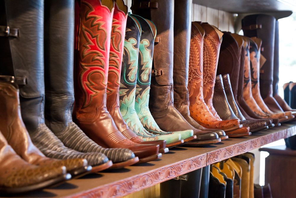 A Row of Cowboy Boots Are Lined Up on a Shelf in a Store — MacCallum & Company In Scone, NSW
